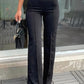 black pants, wide legs, and a pin-tuck front.